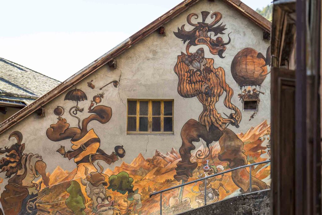 an alpine village house, painted with quirky cow art