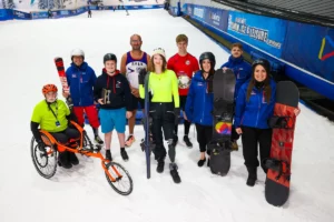 a group of people stand on snow for a photo taken from above for a DSUK fund raising shoot