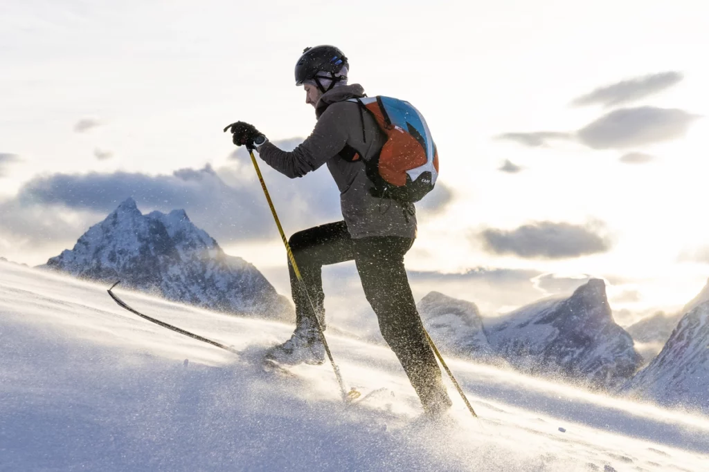 Ultra athlete Kilian Jornet ski touring uphill in the high snowy mountains