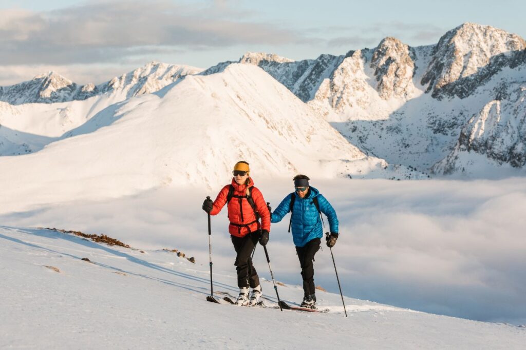 Couple Ski Touring in Andorra: A couple ski touring in the Andorran Pyrenees, with snow-covered peaks and a stunning alpine backdrop.