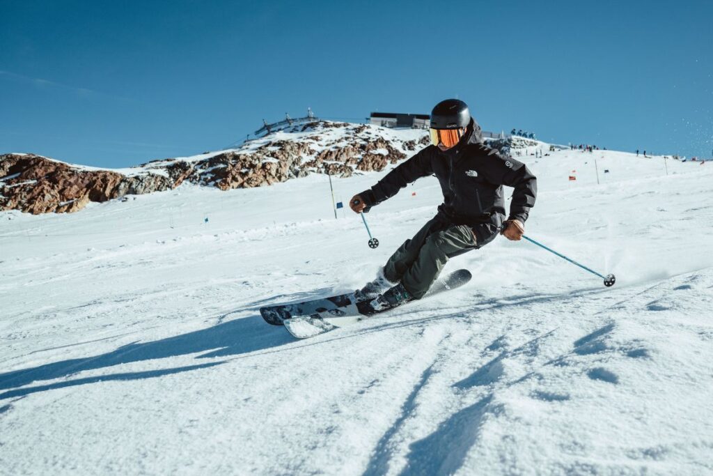 Skier carving on a groomed slope, testing Carv 2's real-time feedback capabilities.